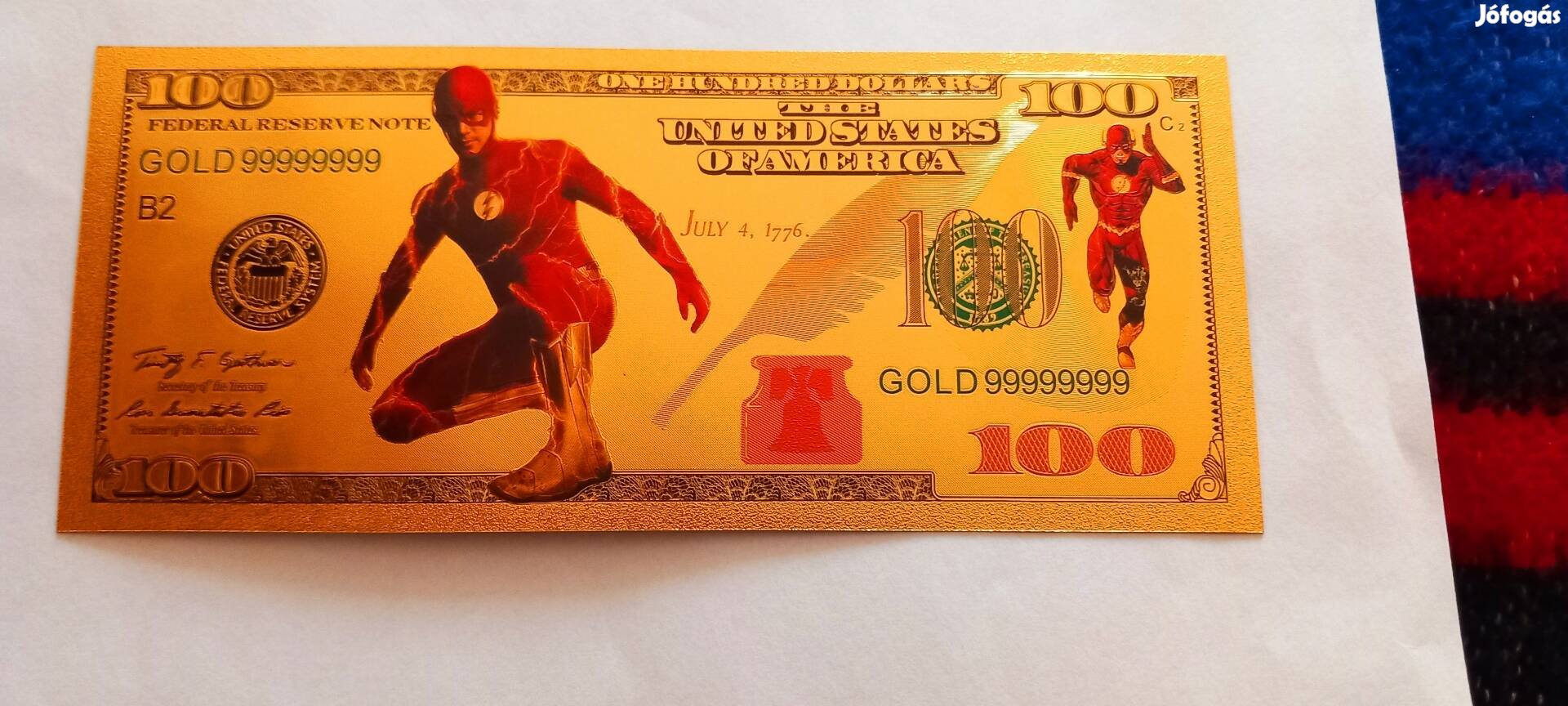 Flash, a villám - színes, aranyozott, plasztik, fantázia 100 dollár. 