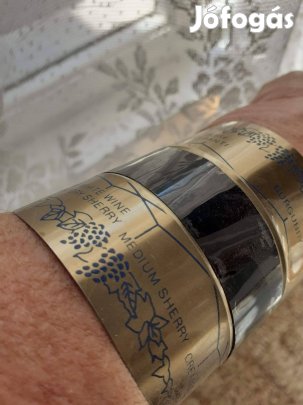 Az üvegben lévő ital hőfokát mérő fém karperec hőmérő