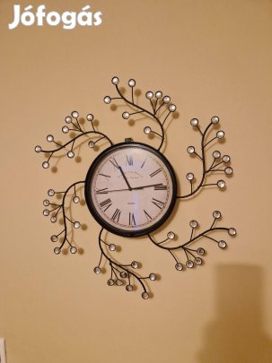 Elemes falióra fémkeretben üveggyöngy díszítéssel