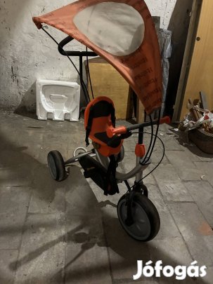 Narancssárga, tetővel ellátott gyerek háromkerekű, tolókarral