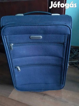 Sötétkék puha falú gurulós bőrönd kis hibával